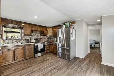 a kitchen with a refrigerator a sink and cabinets