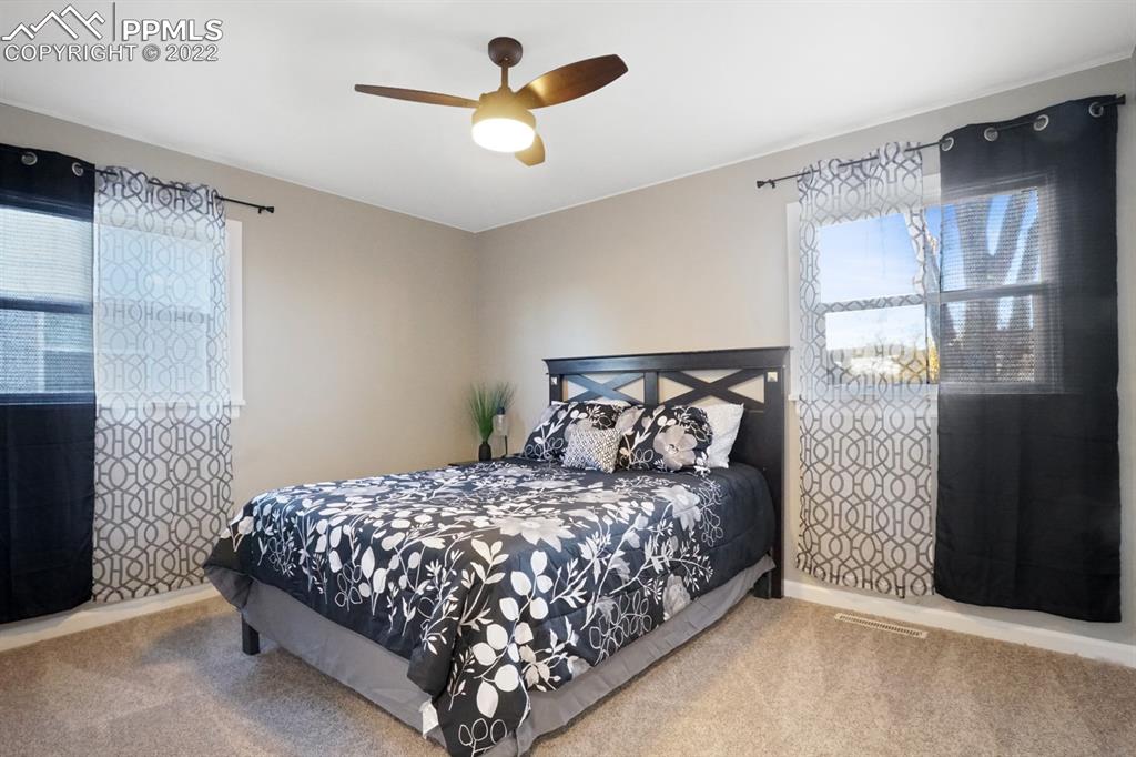 1901 Ridgewood Lane Pueblo, CO 81005 - Photo 12 of 29 a bedroom with a bed and a chandelier