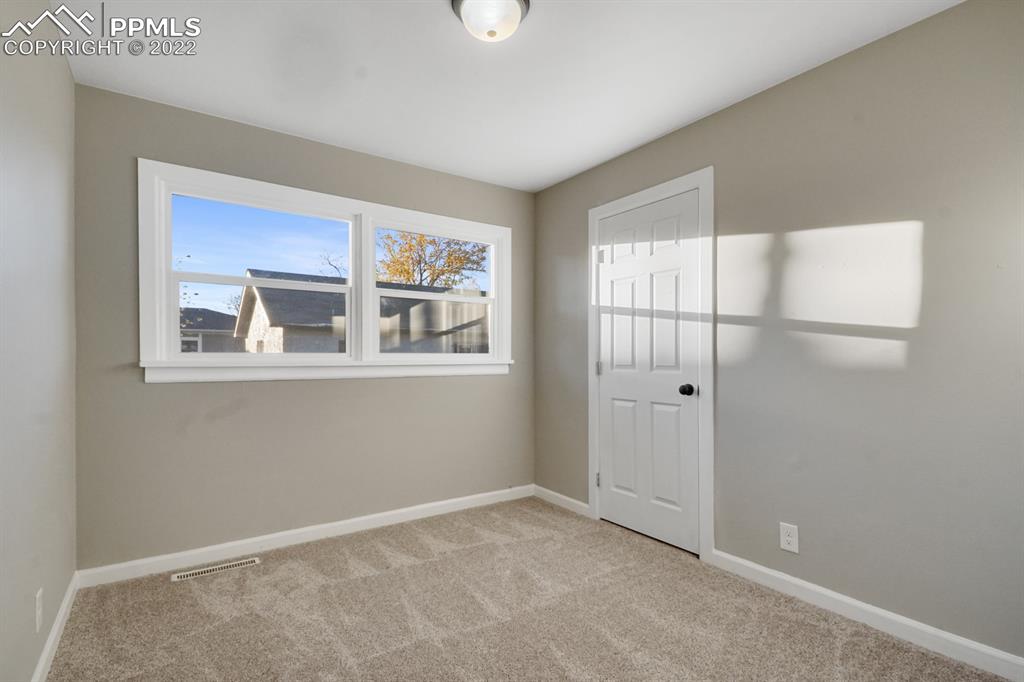 1901 Ridgewood Lane Pueblo, CO 81005 - Photo 15 of 29 a view of an empty room with a window