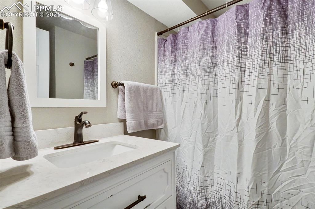 1901 Ridgewood Lane Pueblo, CO 81005 - Photo 16 of 29 a bathroom with a sink and a mirror