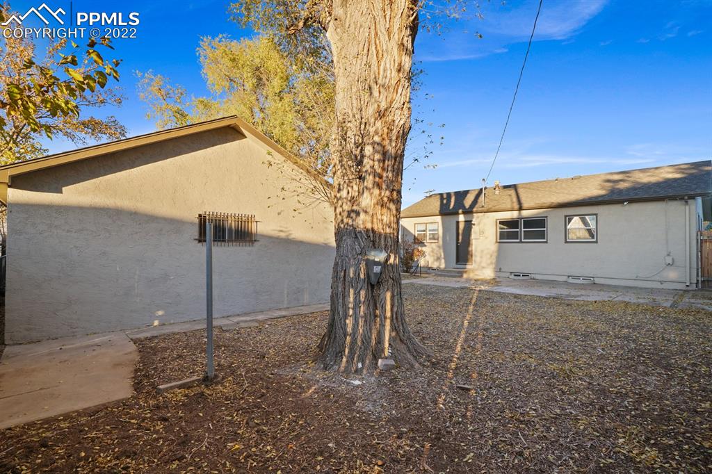 1901 Ridgewood Lane Pueblo, CO 81005 - Photo 24 of 29 a backyard of a house with a tree