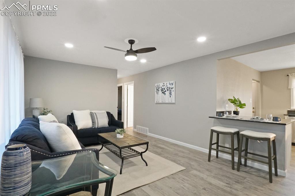 1901 Ridgewood Lane Pueblo, CO 81005 - Photo 7 of 29 a living room with furniture and a wooden floor