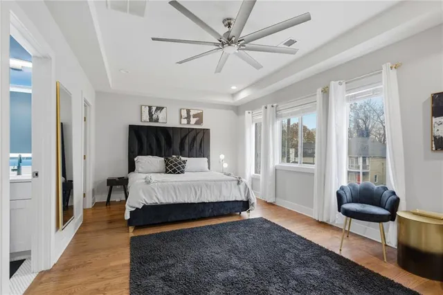 a bathroom with a granite countertop sink a toilet and a mirror