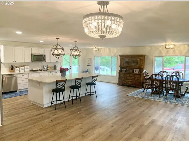 a living room with a fireplace and a large window