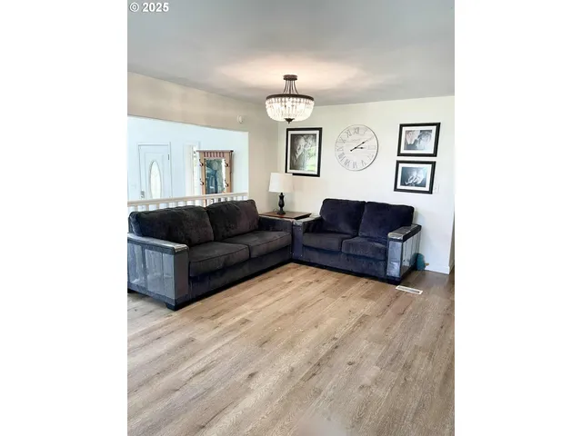 a living room with furniture rug and window