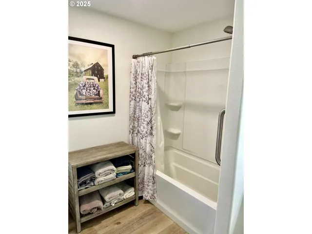 a bedroom with a bed and a painting on the wall