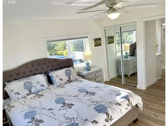 a view of a roof deck with table and chairs with wooden floor and fence