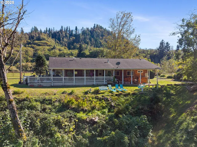a backyard of a house with table and chairs