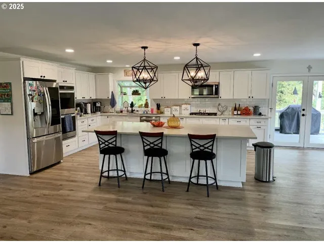 a large kitchen with a table and chairs in it