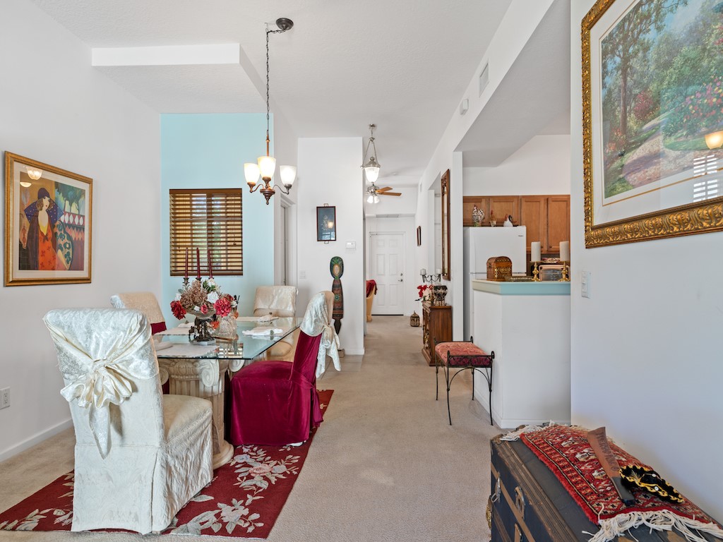 572 7th Square Southwest, Unit 101 Vero Beach, FL 32962 - Photo 16 of 34 a living room with furniture and a chandelier