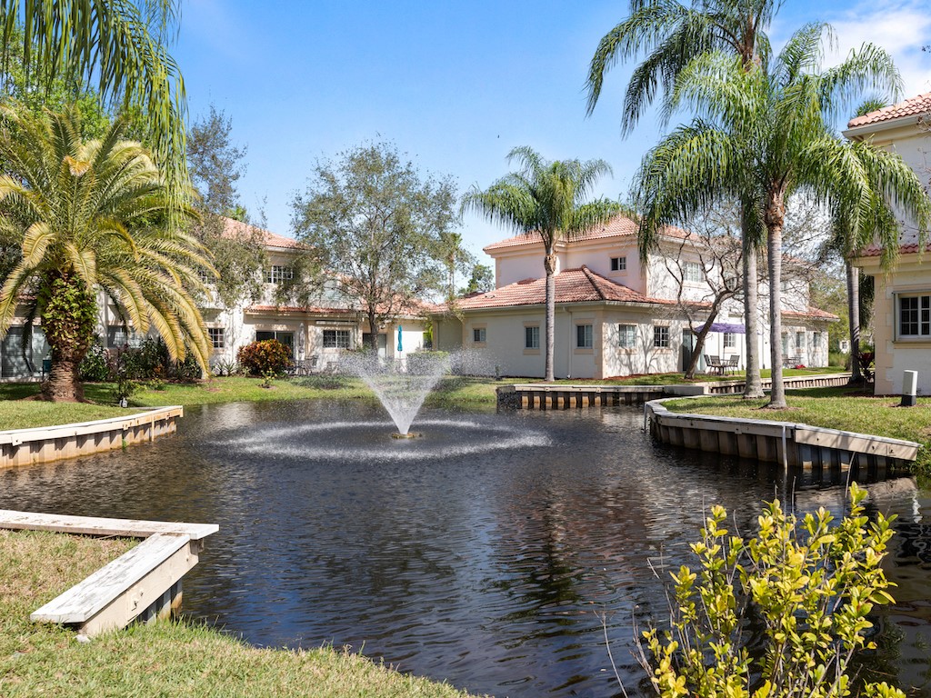 572 7th Square Southwest, Unit 101 Vero Beach, FL 32962 - Photo 2 of 34 a view of a lake with palm trees