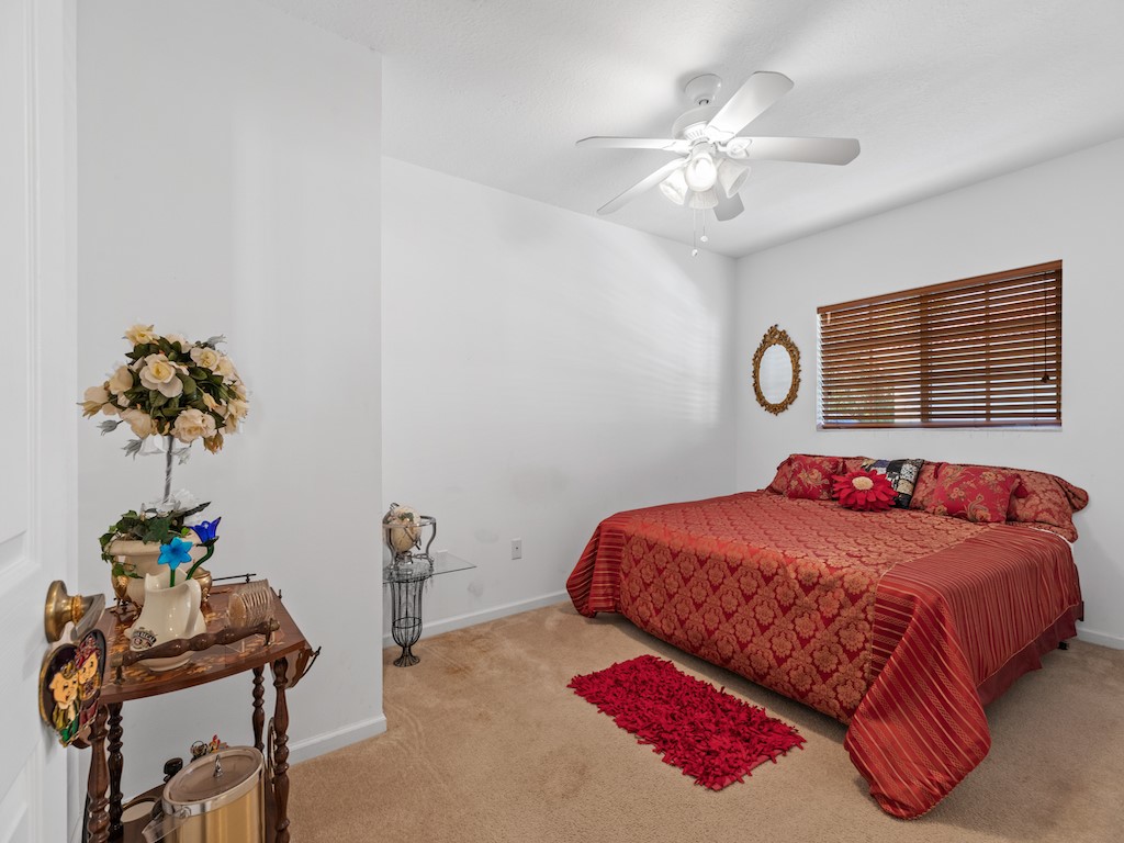 572 7th Square Southwest, Unit 101 Vero Beach, FL 32962 - Photo 22 of 34 a bedroom with a bed and a chandelier