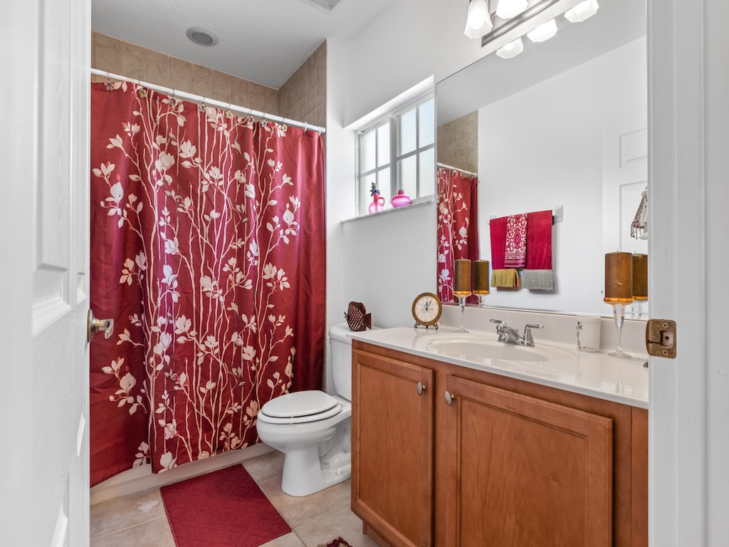 572 7th Square Southwest, Unit 101 Vero Beach, FL 32962 - Photo 23 of 34 a bathroom with a sink toilet and shower