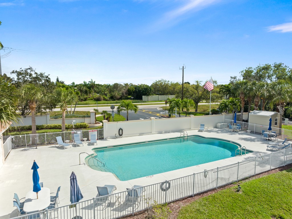 572 7th Square Southwest, Unit 101 Vero Beach, FL 32962 - Photo 3 of 34 a view of a swimming pool with a patio
