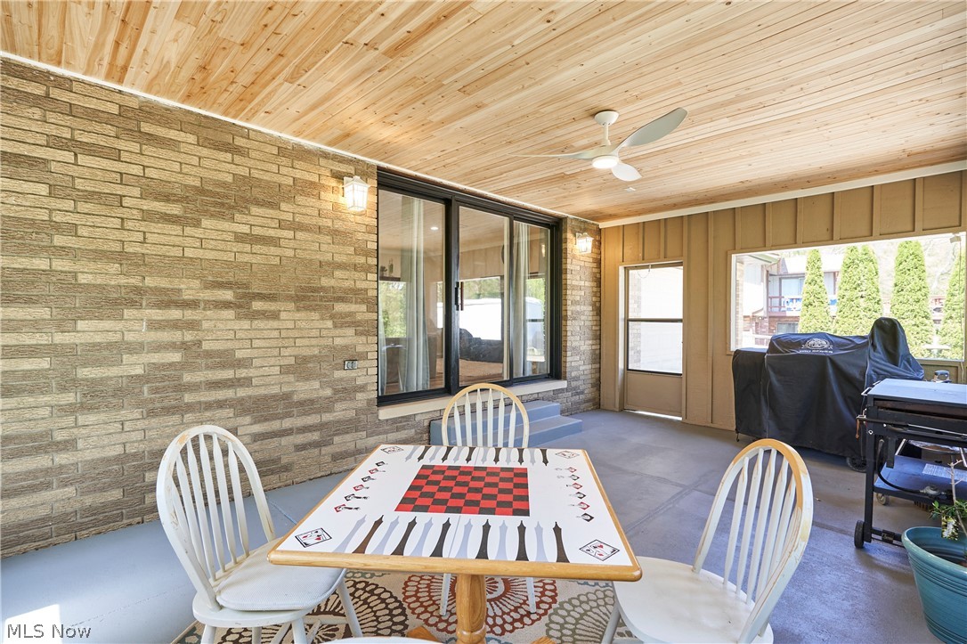 1535 Belle Meade Drive Akron, OH 44321 - Photo 20 of 33 Wonderful sun porch off family room to enjoy the rainy evenings! This cozy space provides a perfect retreat for relaxation and offers a beautiful view, making it ideal for unwinding on those special evenings.