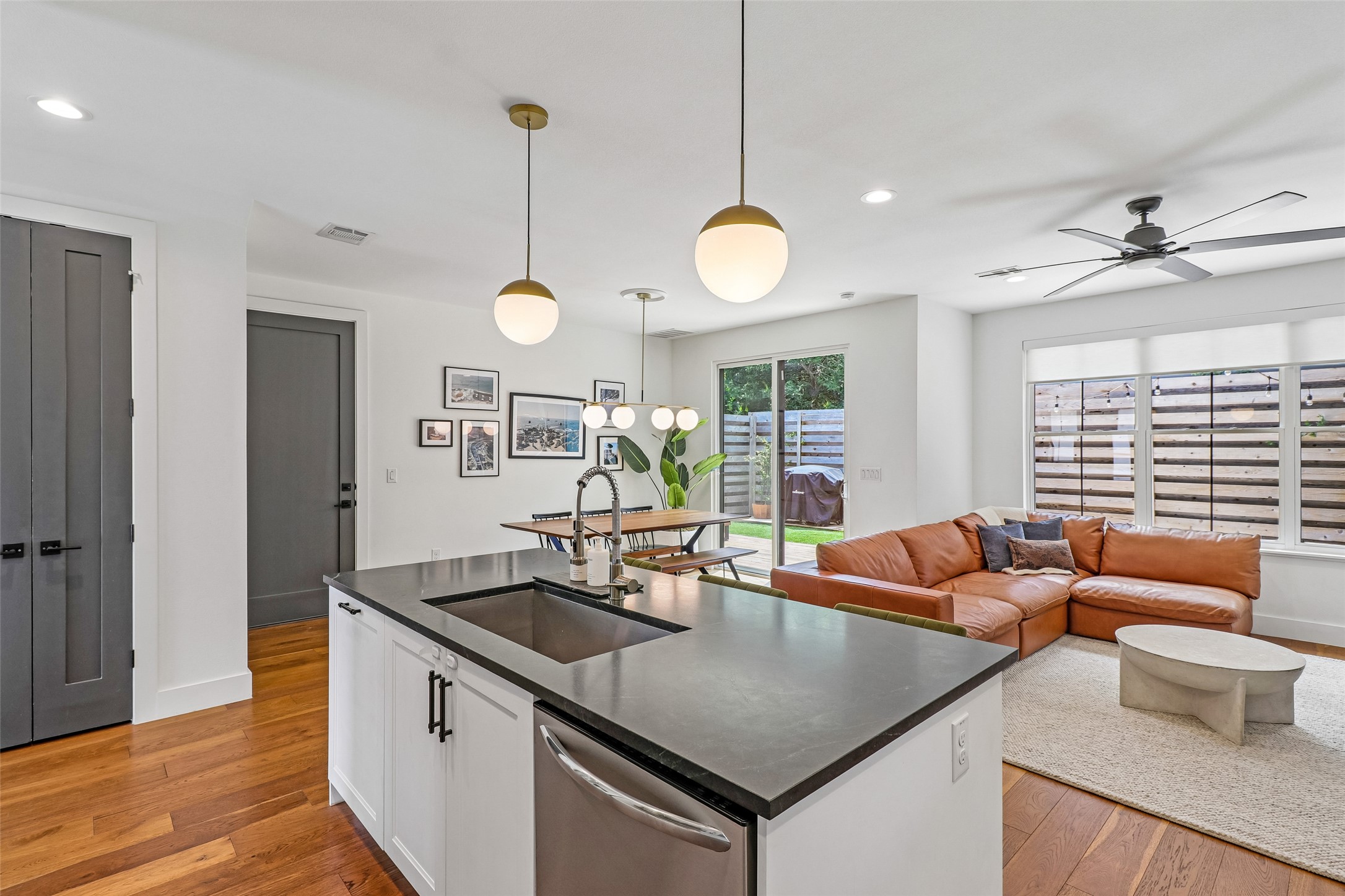 1706 Perez Street, Unit 1 Austin, TX 78721 - Photo 11 of 36 Hardwood floors complement an open concept layout with a modern kitchen island and direct yard access.