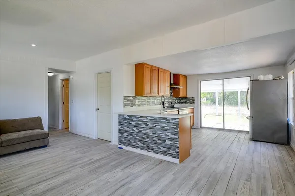 a living room with a bed furniture and a large window