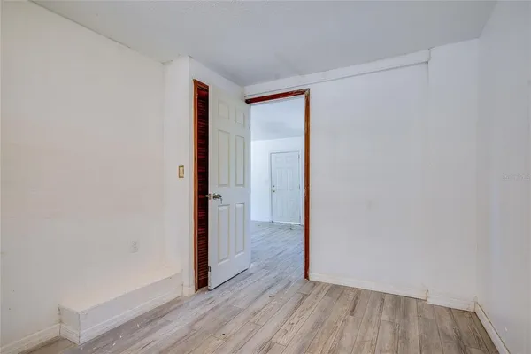 a view of hallway with wooden floor