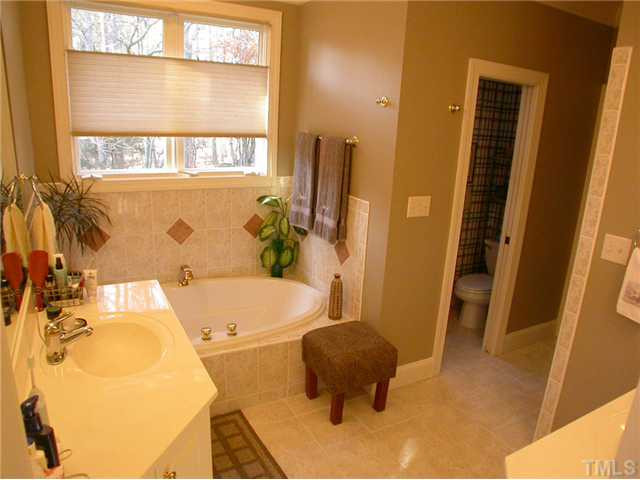 163 Yorkchester Way Raleigh, NC 27615 - Photo 16 of 25 Glamourous master bath with tile flooring, tub, seperate walk in shower and dual vanities. Master Bath/Spa