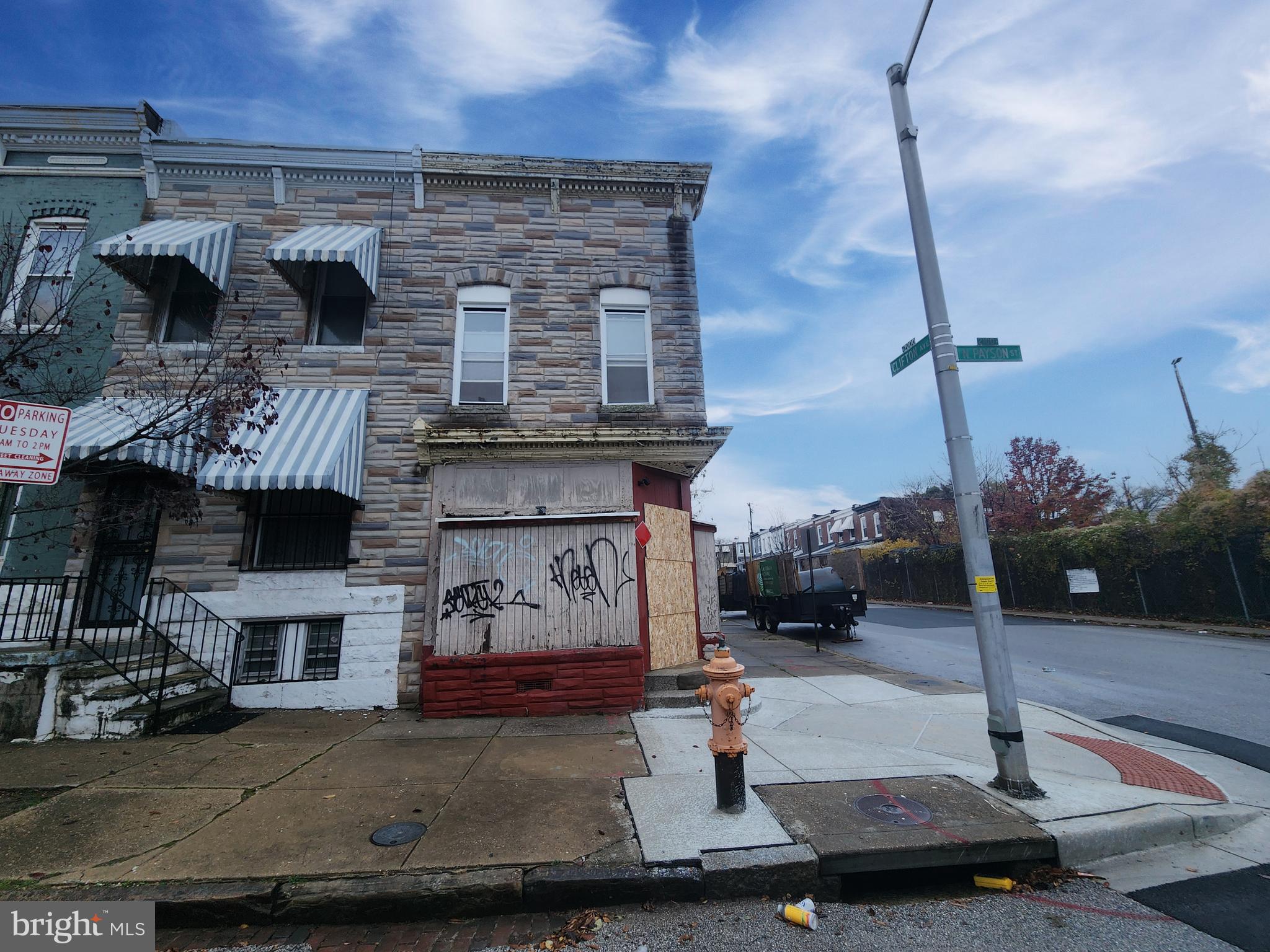 2028 North Payson Street Baltimore, MD 21217 - Photo 2 of 5 a building with table and chairs in front of it