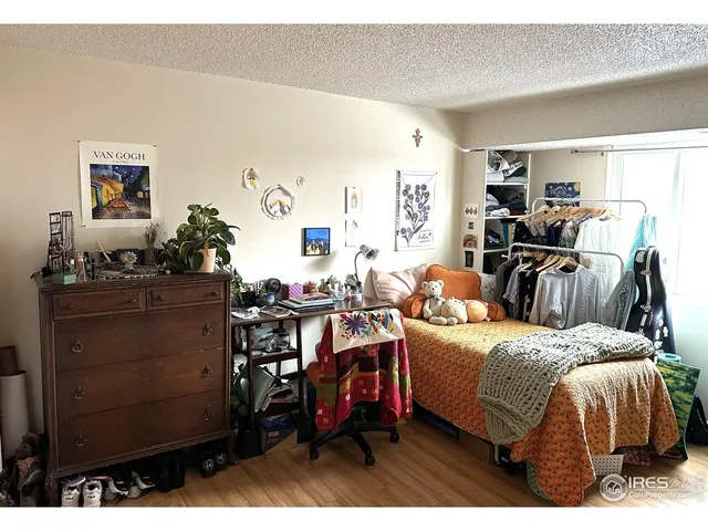 a bedroom with furniture and a wooden floor