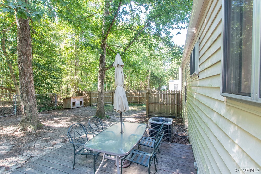 10313 Ridgerun Road Chesterfield, VA 23832 - Photo 16 of 22 a view of a patio with table and chairs and wooden floor
