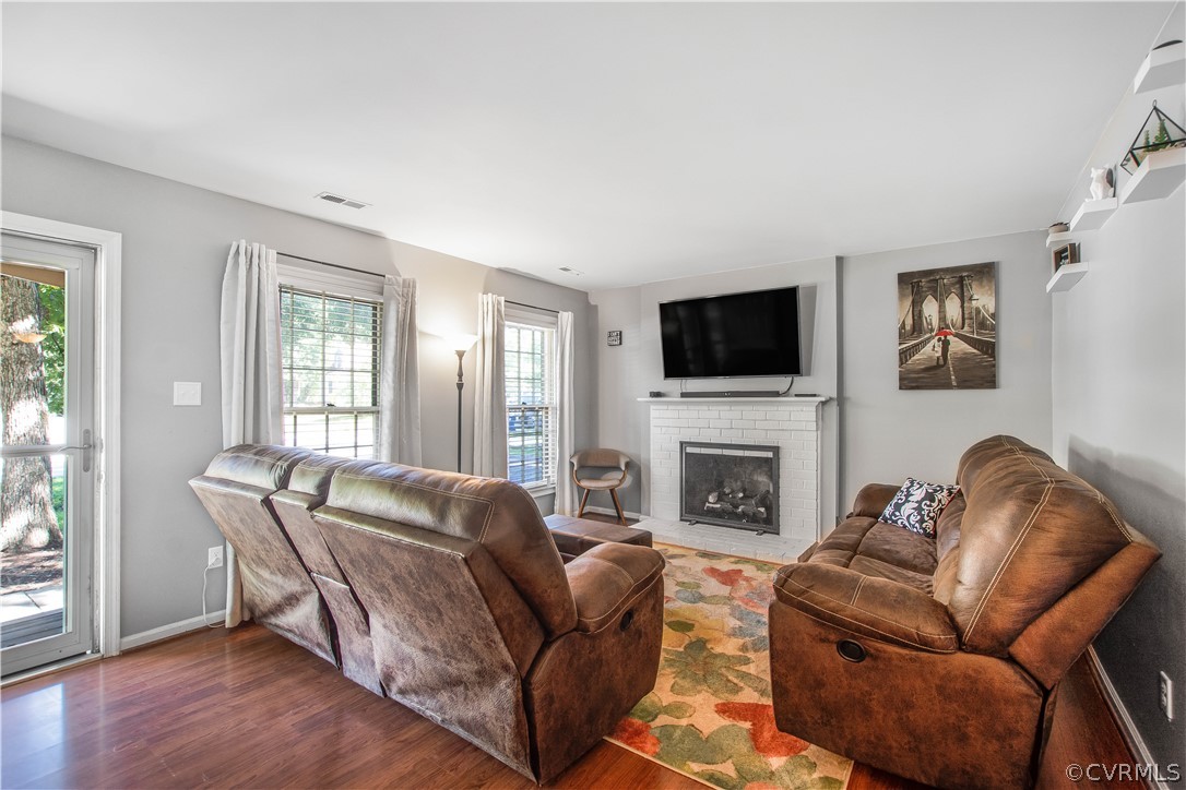 10313 Ridgerun Road Chesterfield, VA 23832 - Photo 2 of 22 a living room with furniture a flat screen tv and a fireplace