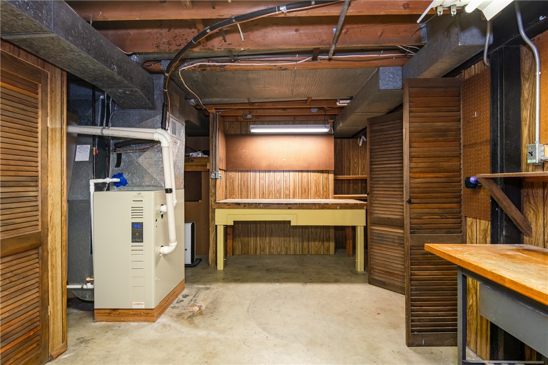 1176 Geneva Road Dayton, OH 45434 - Photo 33 of 55 This versatile basement space features a utility area and an integrated workbench, ideal for various projects.