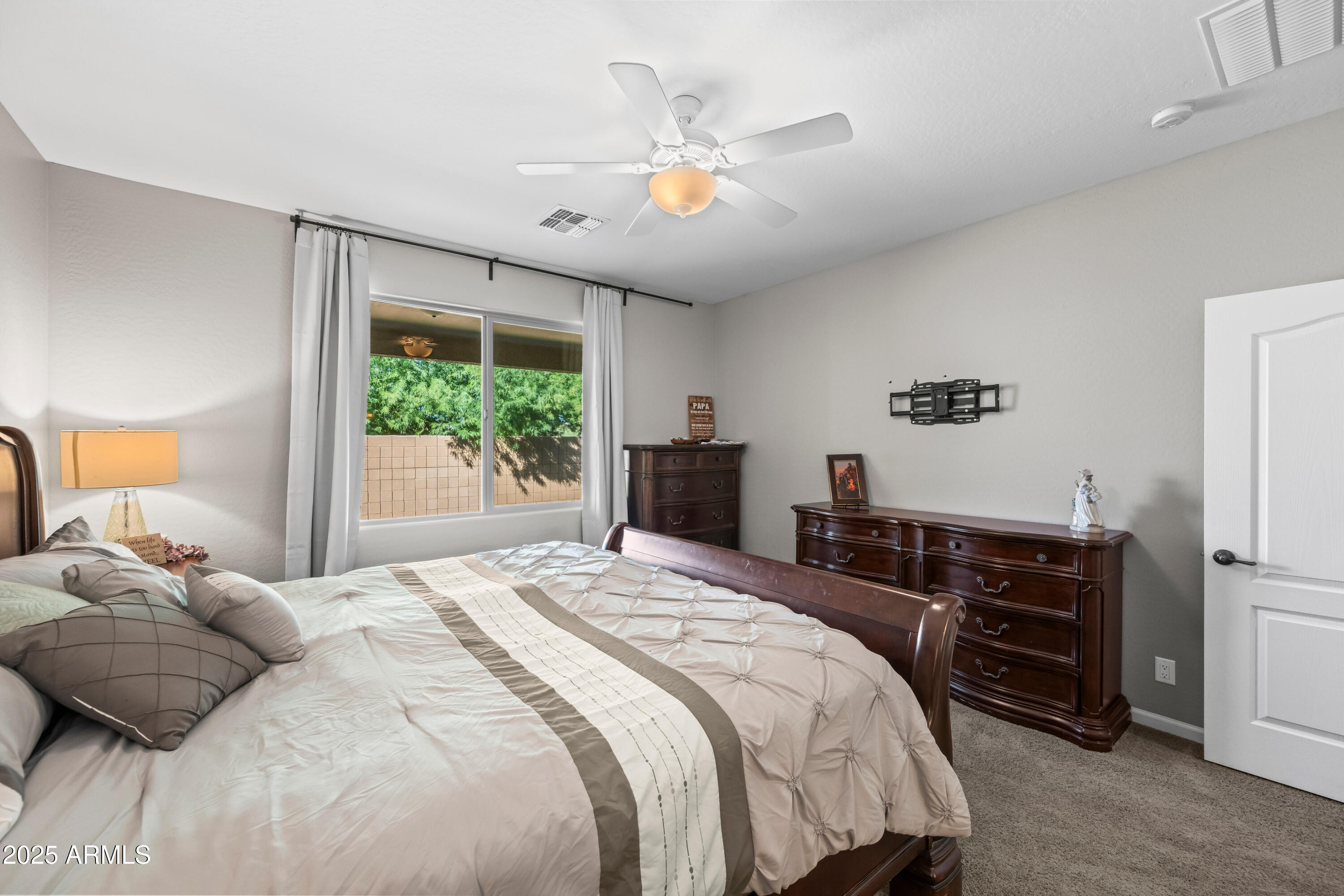 3117 South Signal Butte Road, Unit 474 Mesa, AZ 85212 - Photo 11 of 24 a bedroom with a bed and a chandelier