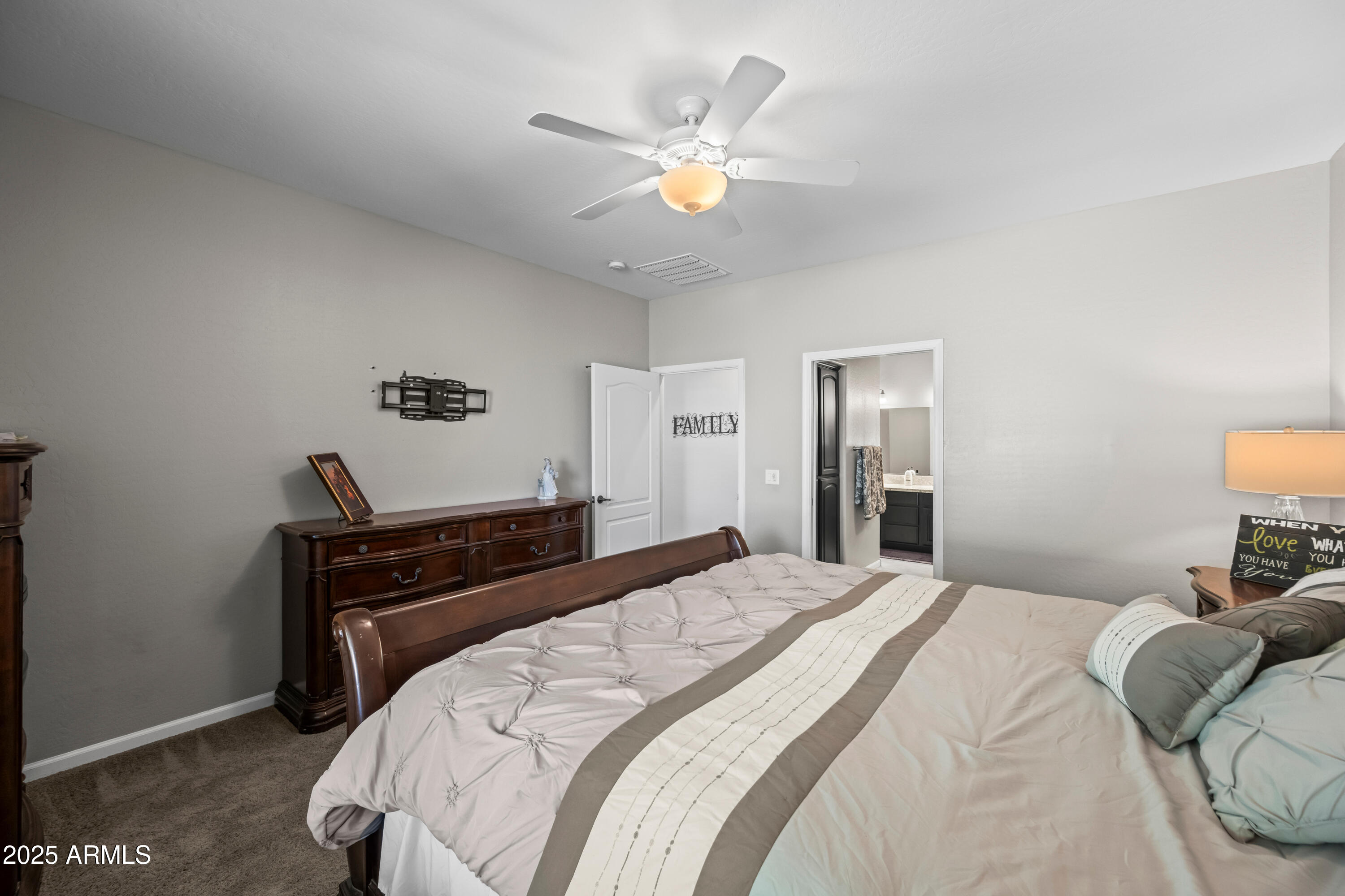 3117 South Signal Butte Road, Unit 474 Mesa, AZ 85212 - Photo 12 of 24 a bedroom with a bed and a ceiling fan