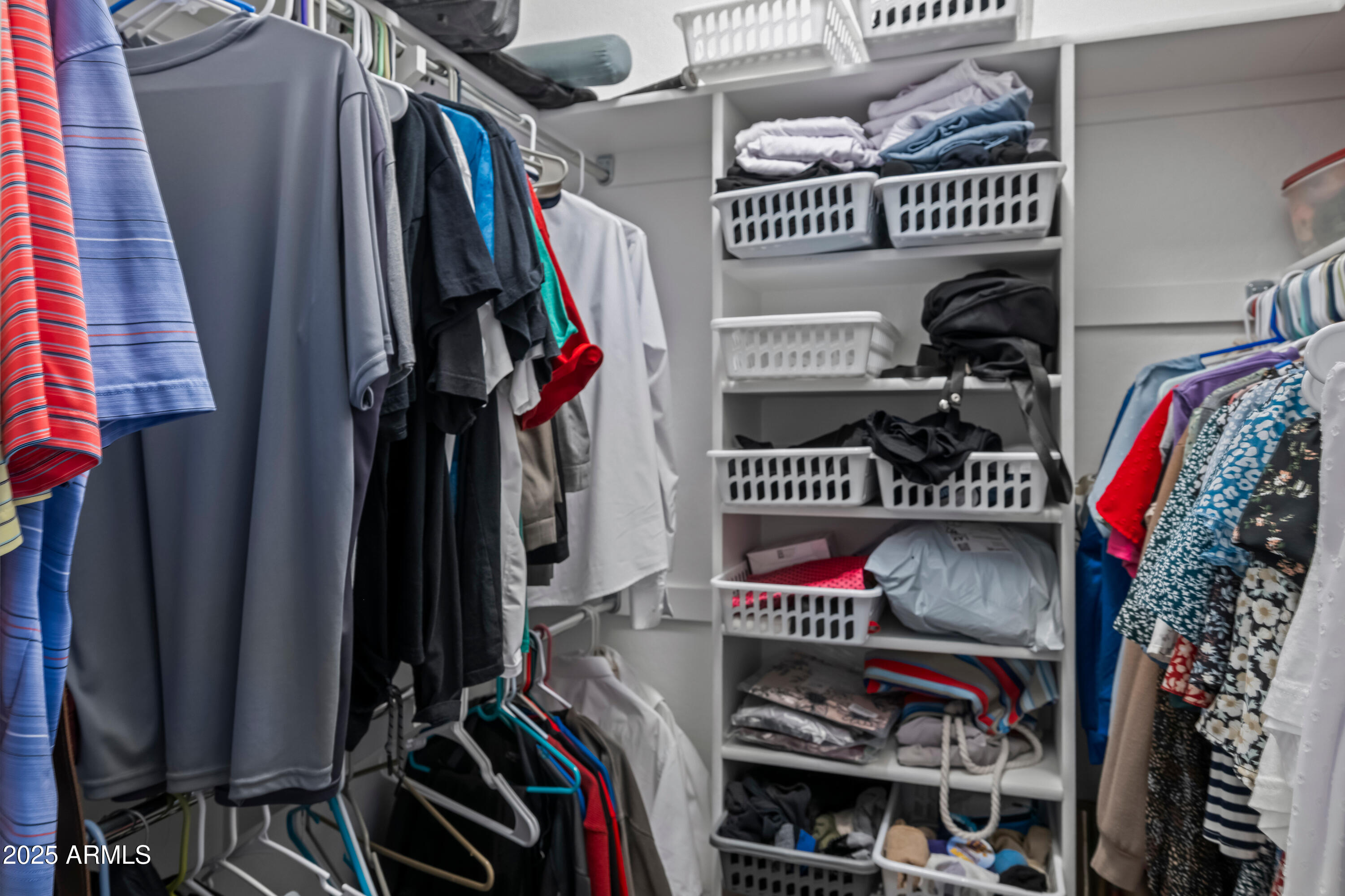 3117 South Signal Butte Road, Unit 474 Mesa, AZ 85212 - Photo 13 of 24 a view of walk in closet with clothes and shoes