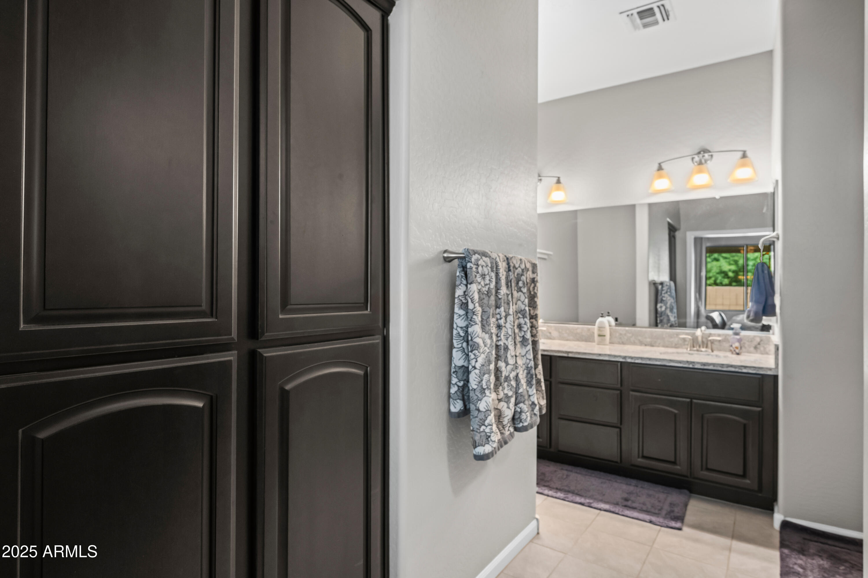 3117 South Signal Butte Road, Unit 474 Mesa, AZ 85212 - Photo 16 of 24 a bathroom with a double vanity sink and a mirror
