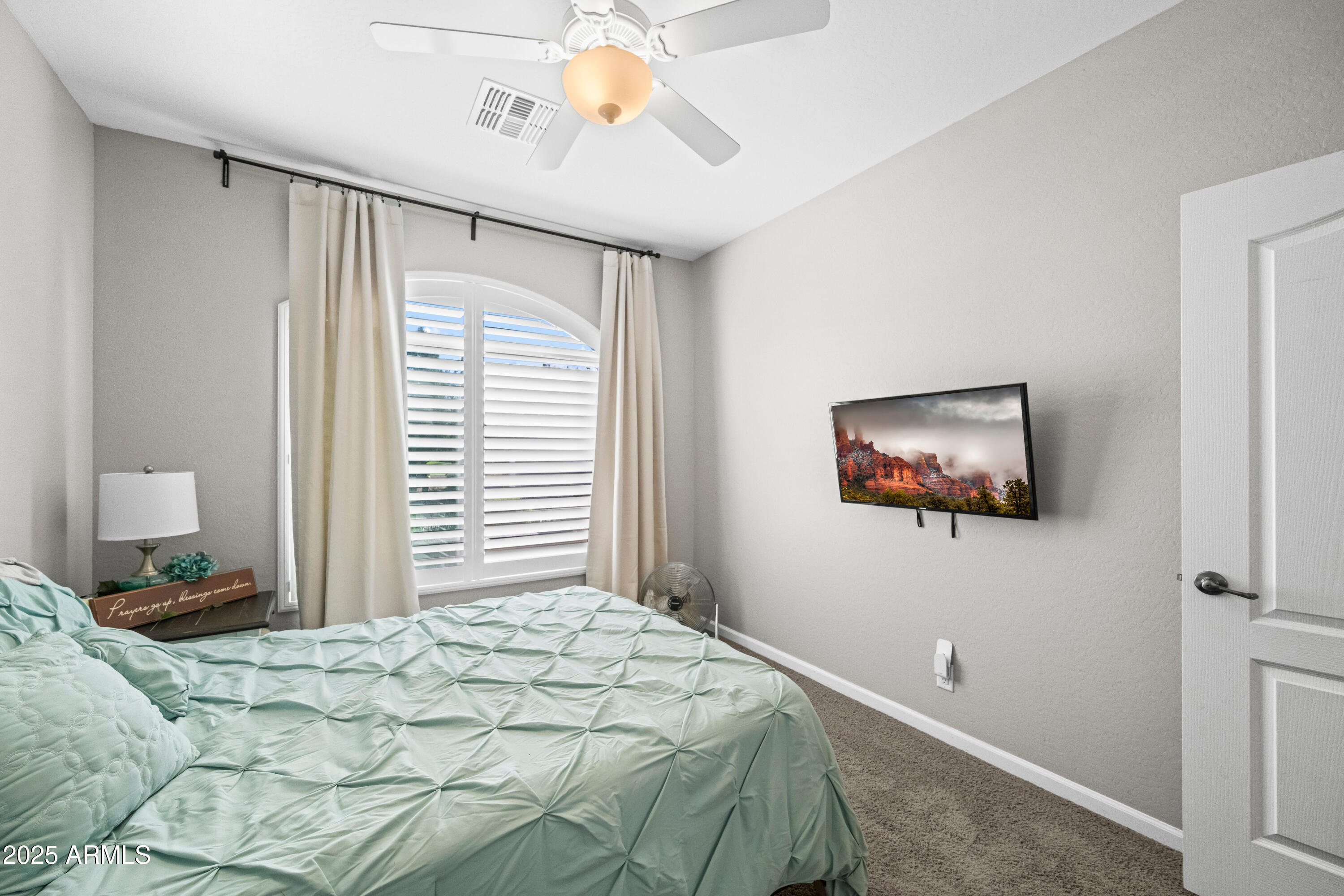 3117 South Signal Butte Road, Unit 474 Mesa, AZ 85212 - Photo 19 of 24 a bedroom with a bed and a painting on the wall