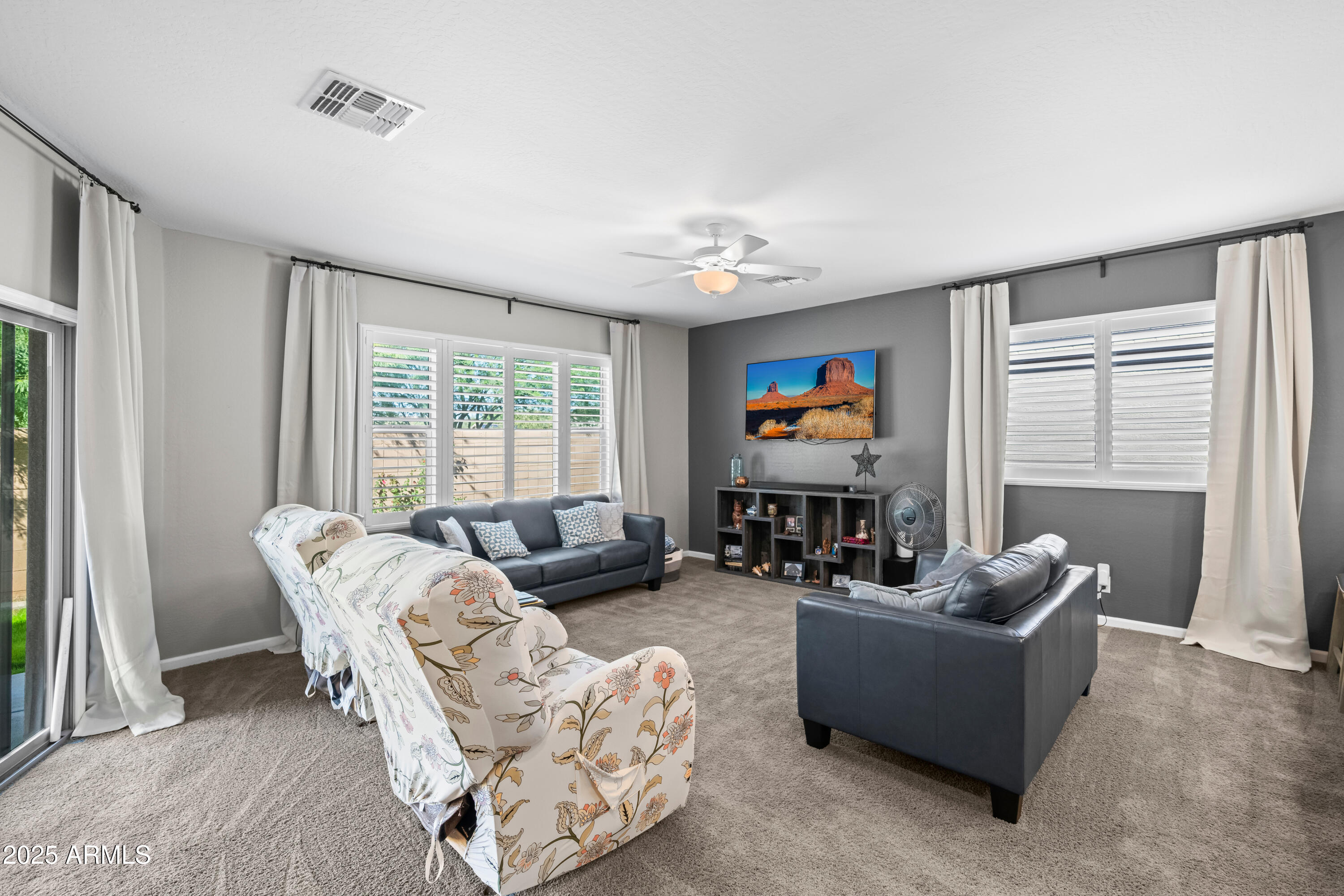 3117 South Signal Butte Road, Unit 474 Mesa, AZ 85212 - Photo 4 of 24 a living room with furniture and a flat screen tv