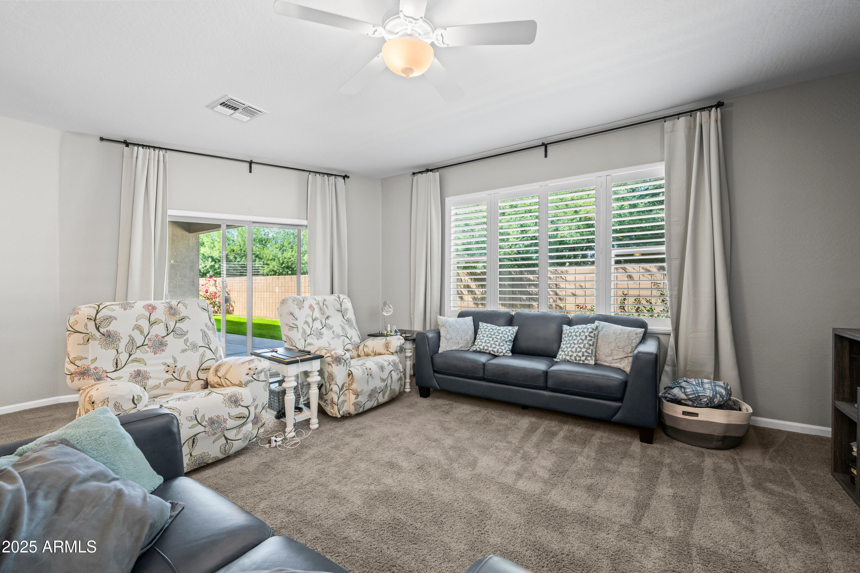 3117 South Signal Butte Road, Unit 474 Mesa, AZ 85212 - Photo 5 of 24 a living room with furniture and a large window