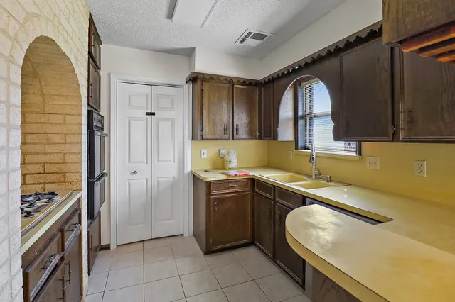 a kitchen with stainless steel appliances granite countertop a sink and cabinets