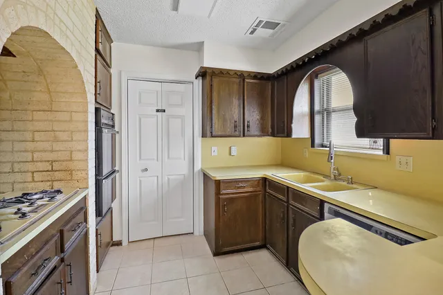 a kitchen with a sink stove and cabinets