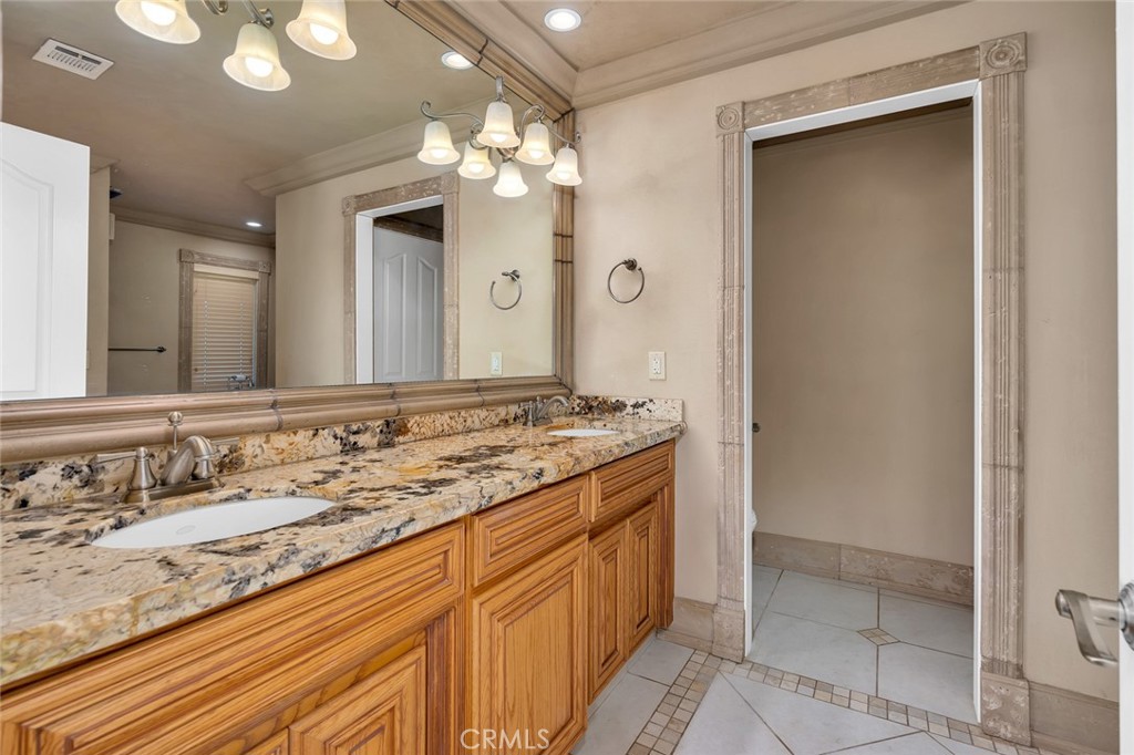 33318 Ave 12 Madera, CA 93636 - Photo 51 of 69 a bathroom with a granite countertop sink a large mirror and a shower