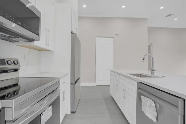 a kitchen with a sink and cabinets
