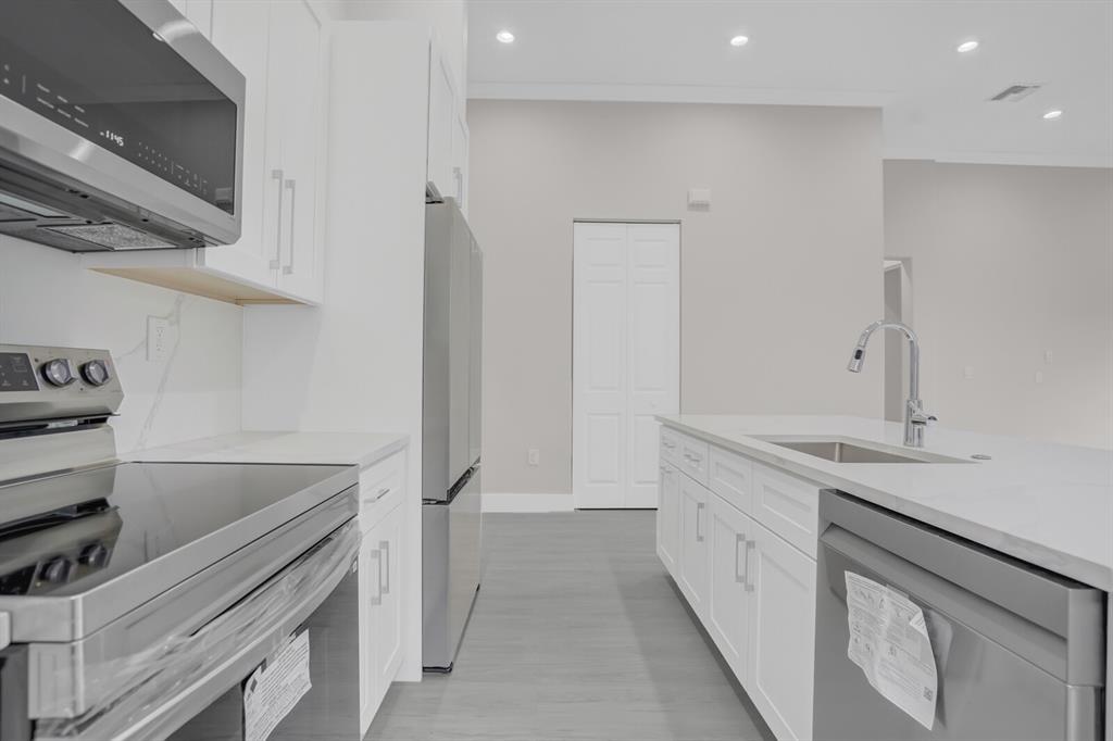 8504 Northwest 37th Court Pembroke Pines, FL 33024 - Photo 11 of 32 a kitchen with a sink and cabinets