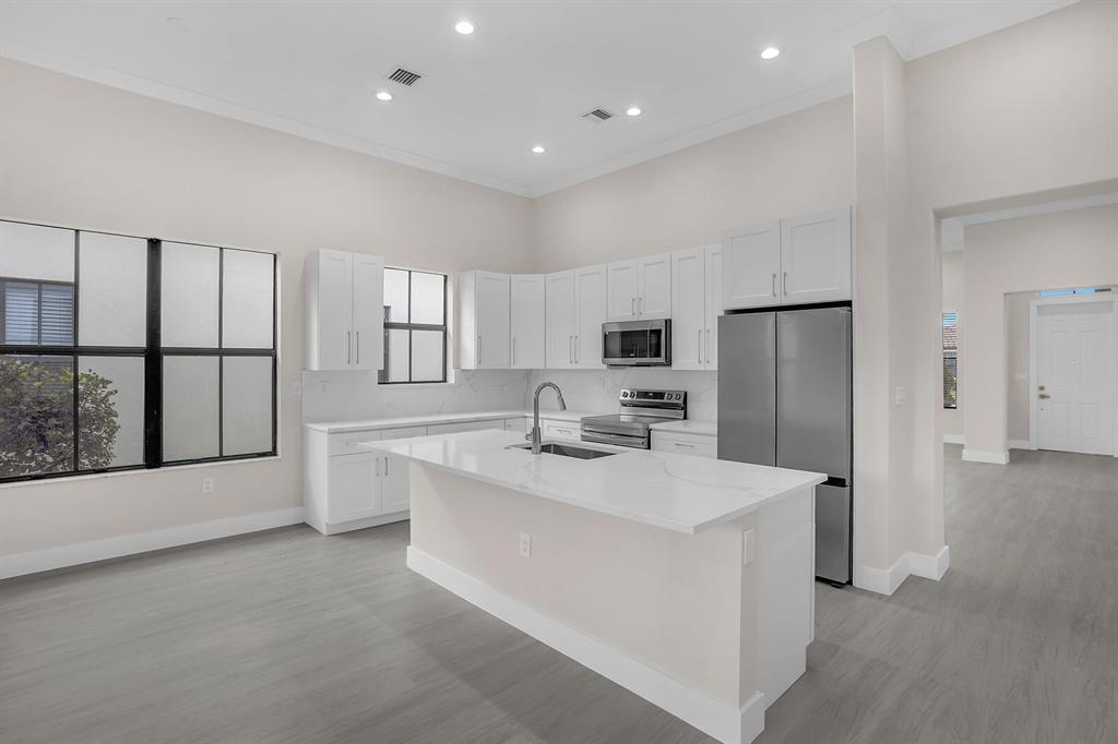 8504 Northwest 37th Court Pembroke Pines, FL 33024 - Photo 12 of 32 a kitchen with stainless steel appliances a refrigerator sink and cabinets