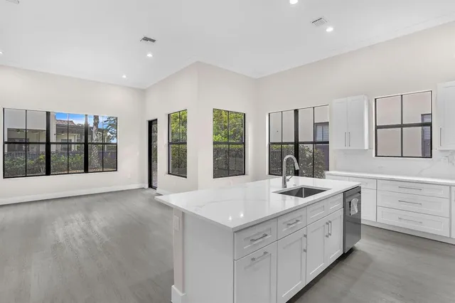 a kitchen with sink and mirror