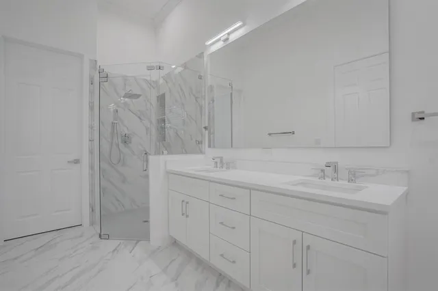 a bathroom with double sink and a mirror