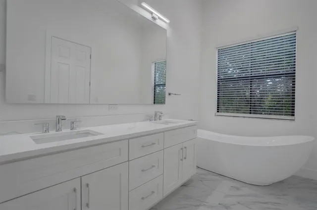 a bathroom with a bathtub and a sink