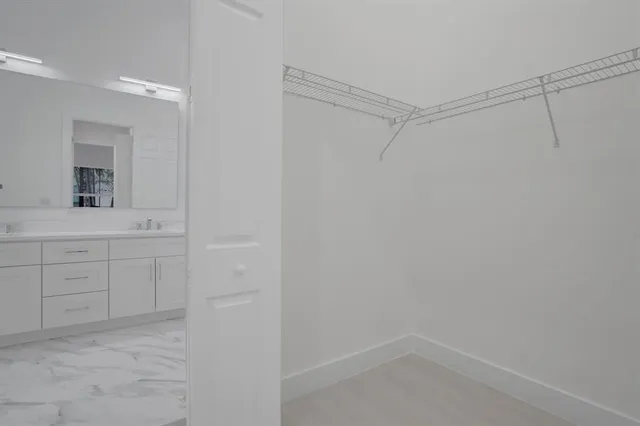 a bathroom with a shower and vanity