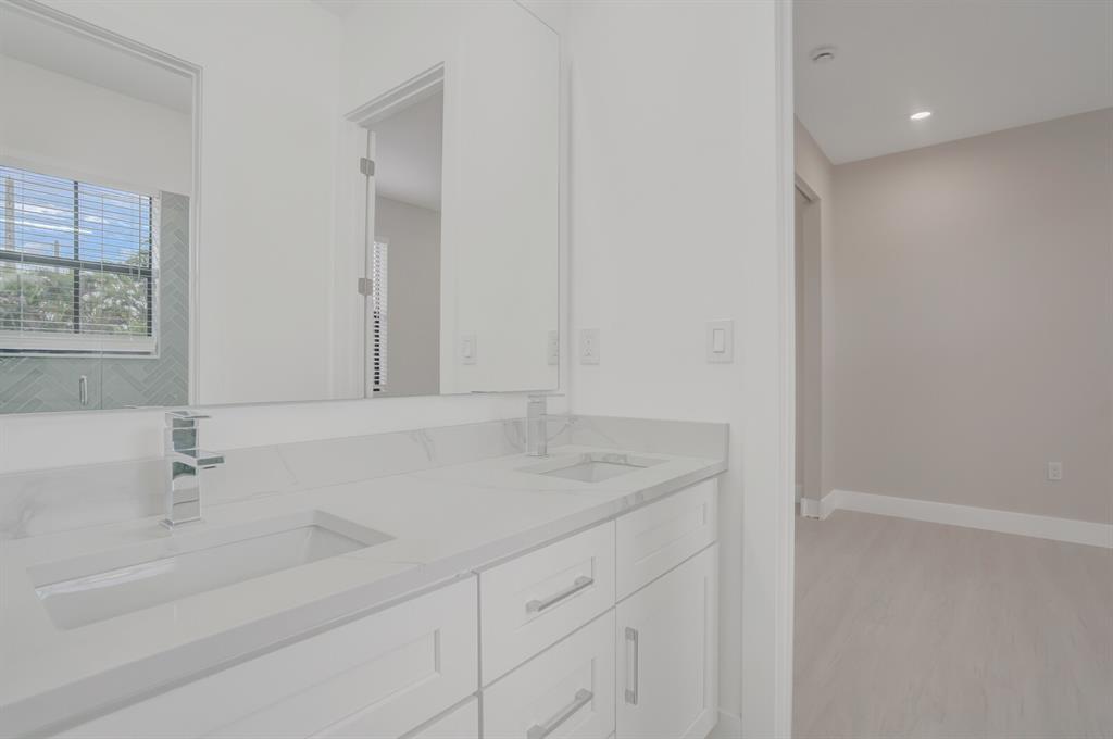 8504 Northwest 37th Court Pembroke Pines, FL 33024 - Photo 22 of 32 a bathroom with a sink and a mirror