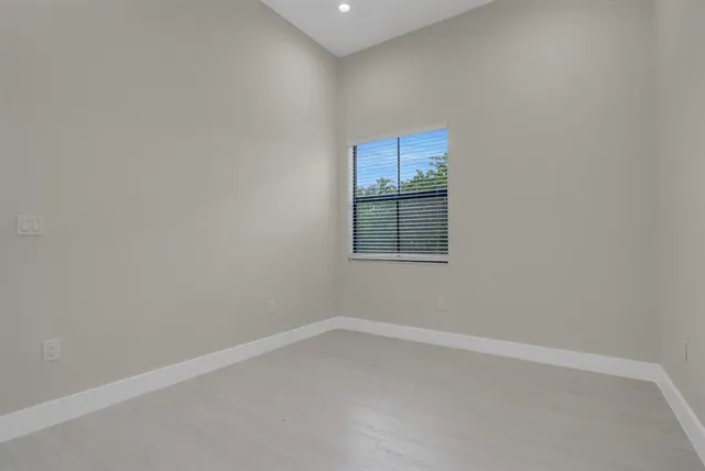 an empty room with a empty space and windows