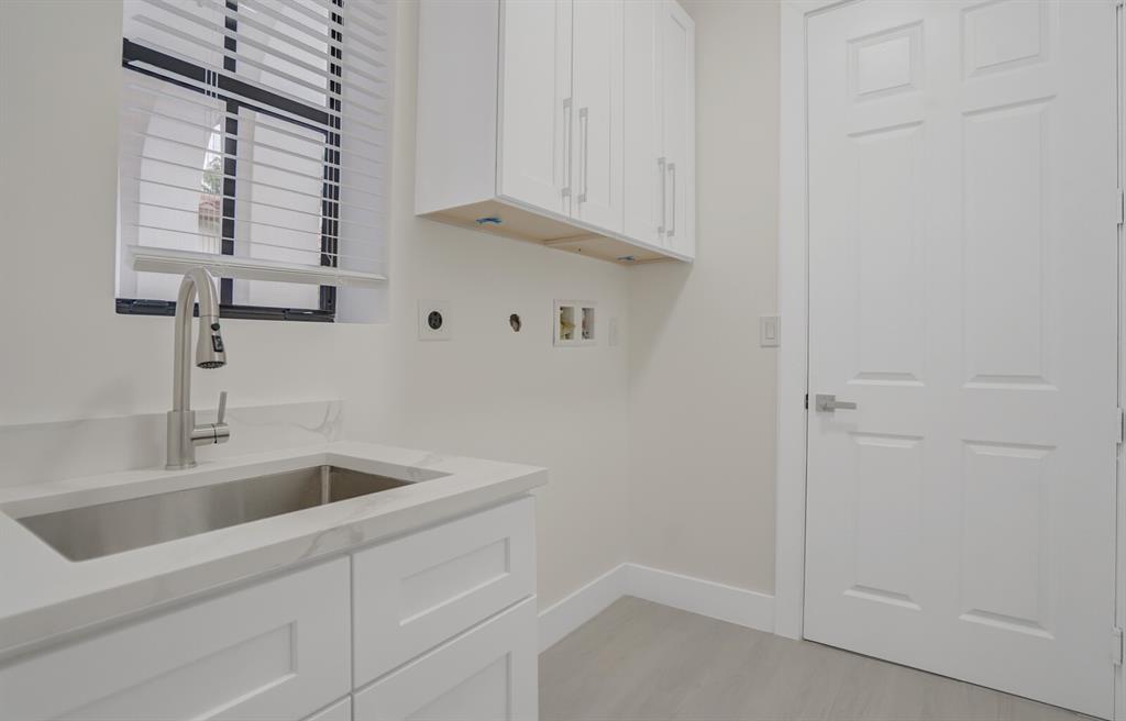 8504 Northwest 37th Court Pembroke Pines, FL 33024 - Photo 27 of 32 a kitchen with a sink and cabinets
