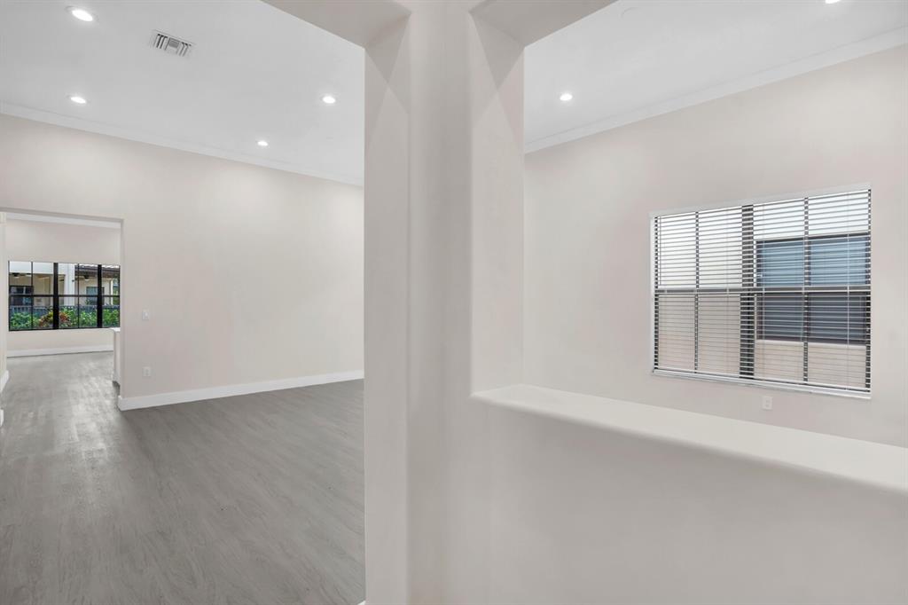 8504 Northwest 37th Court Pembroke Pines, FL 33024 - Photo 6 of 32 an empty room with wooden floor and windows