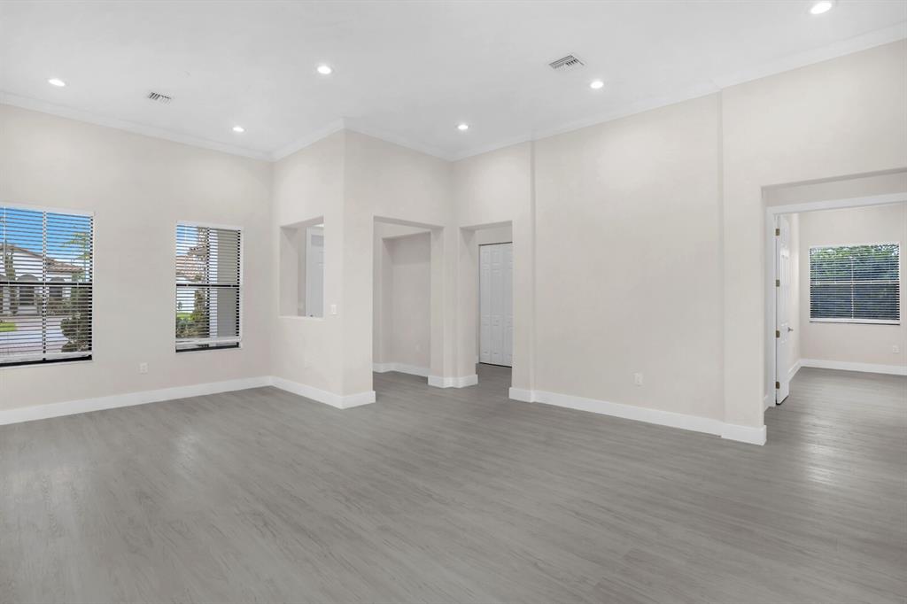 8504 Northwest 37th Court Pembroke Pines, FL 33024 - Photo 8 of 32 an empty room with wooden floor and windows